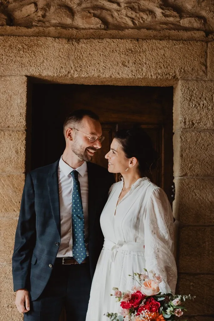 Mariés complices sur le pas d’une porte ancienne, mariage à Rognes